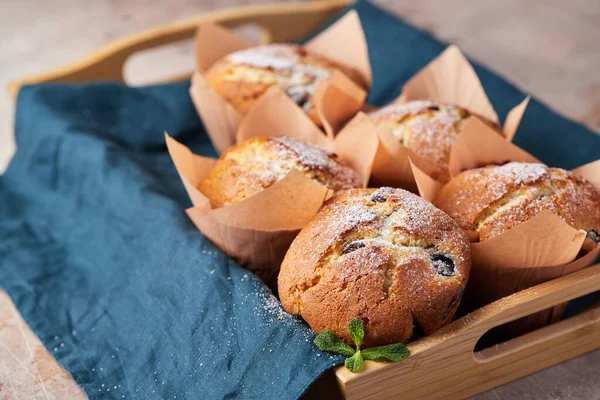 A group of muffins with berries and chocolate on a tray. — Φωτογραφία Αρχείου