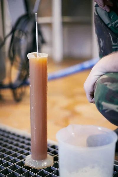 stock image Equipment for the production of handicraft beer. Measurement of the density of the wort, hydrometer in the bulb.