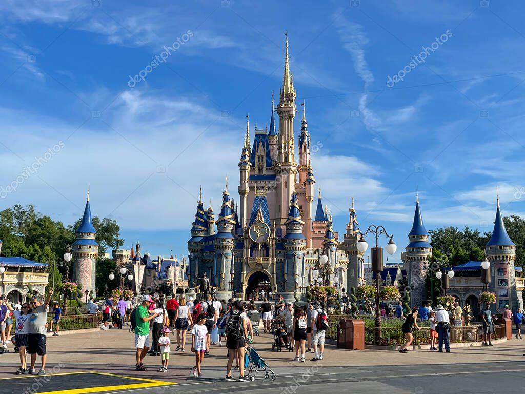 Bay lake, FL USA - September 14, 2022: Roadside view of tourists walking down the main street USA at the magic kingdom park with cinderella castle