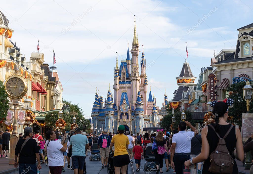 Bay lake, FL USA - September 14, 2022: Roadside view of tourists walking down the main street USA at the magic kingdom park with cinderella castle