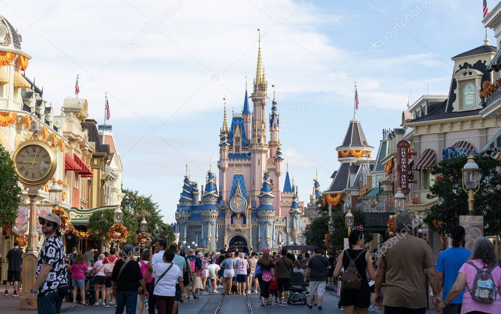 Bay lake, FL USA - September 14, 2022: Roadside view of tourists walking down the main street USA at the magic kingdom park with cinderella castle