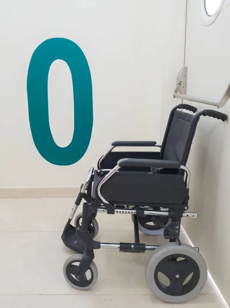 Patient wheelchair on the access floor of a hospital.