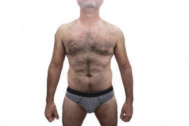 Göğsü kıllı, atletik, yaşlı, beyaz bir adam. Beyaz arkaplanda izole.