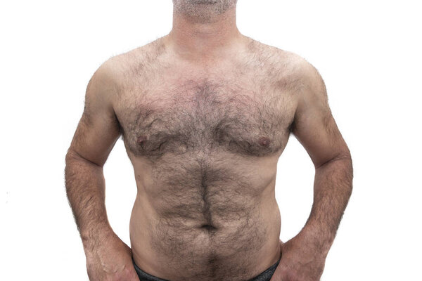 An athletic elderly Caucasian man, with bare hairy chest. Isolated on white background.