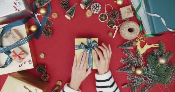 女孩们打开礼品盒 打开红色背景的圣诞装饰品的顶部视图 圣诞传统作曲与新年佳节之间创意最少的平铺 — 图库视频影像
