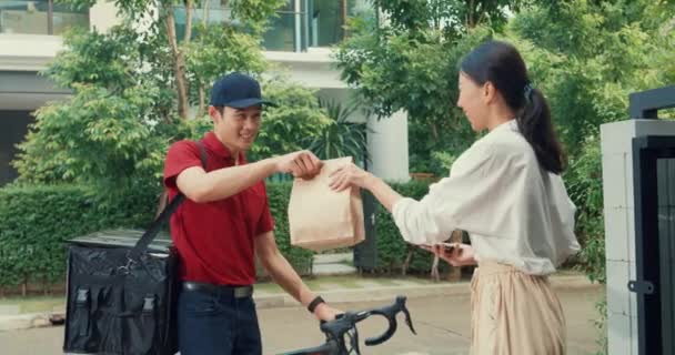 Young Happy Asian Woman Accept Paper Bag Delivery Man Bicycle — 图库视频影像