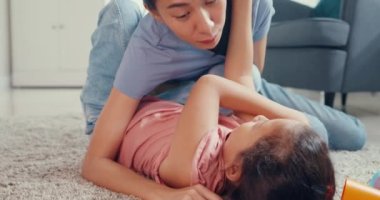 Close-up Asian toddler little girl daughter with mother and playing on carpet on the floor having fun and joyful in living room at home. Family spend time together, Creative lifestyle for kid concept.