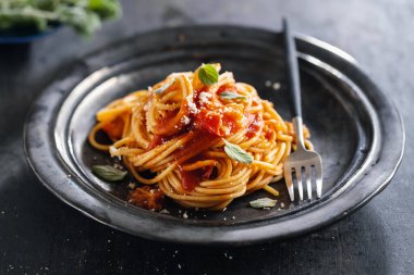 Pasta spaghetti with tomato sauce and cheese served on plate. 