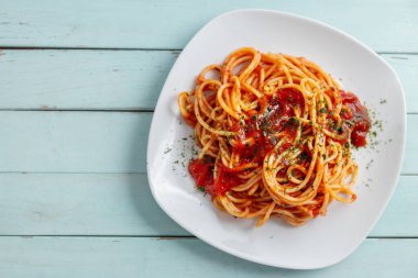 Appetizing pasta with tomato sauce and parmesan on plate. Closeup