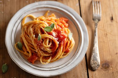 Pasta spaghetti with tomato sauce and cheese served on plate. 