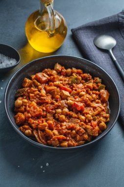Stew vegetables ragout vegan with tofu served in bowl on dark. 