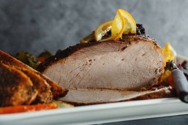 Tasty appetizing roasted meat pork with vegetables for Christmas or Thanksgiving day. Closeup. 
