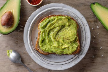 Tasty appetizing sandwich bread with mashed avocado served on plate. 