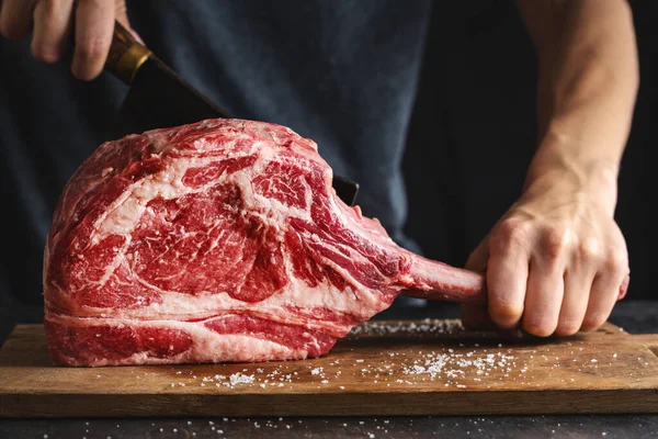 Butcher Cuting Fresh Appetizing Tomahawk Steak Old Wooden Board Closeup — Fotografia de Stock
