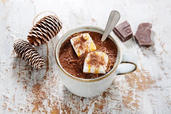 Hot chocolate served in cup with murshmallows on wooden background. 
