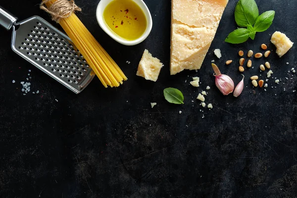 Pesto ingredients on dark background. View from above. 