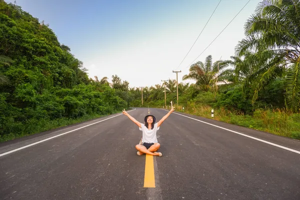 stock image Young asia woman sit on the middle of road