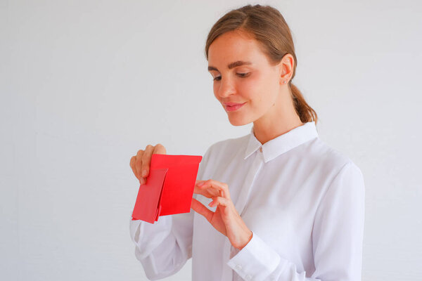 Caucasian woman receive bonus or salary or money with red envelope holding in hand is happily, chinese new year concept