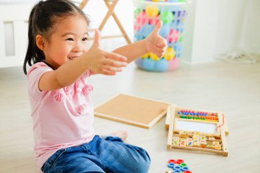 Güzel Asyalı kız oyuncakları oynuyor.