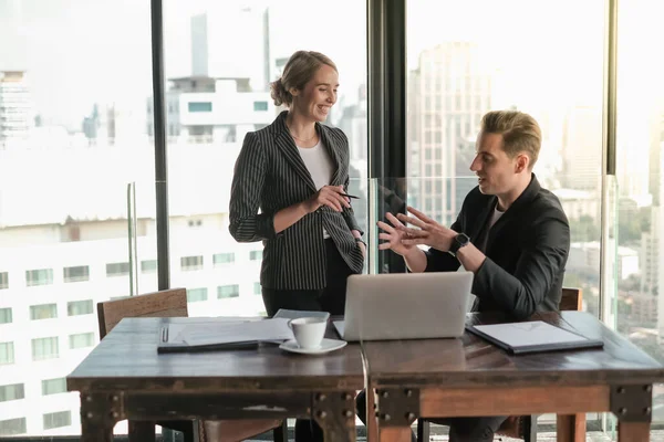 Two businessman and businesswoman couple meeting in co working space at sky lounge or office