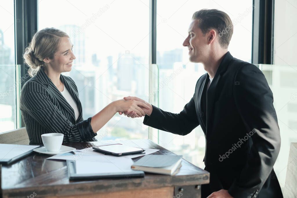 Two businessman and businesswoman couple meeting in co working space at sky lounge or office