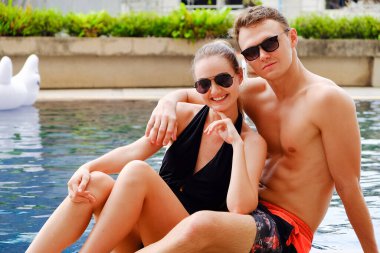 Aşık portre çifti, seksi bikini havuz başı partisi yüzme havuzunda eğlenmek yaz mevsiminde mutlu bir hayat.