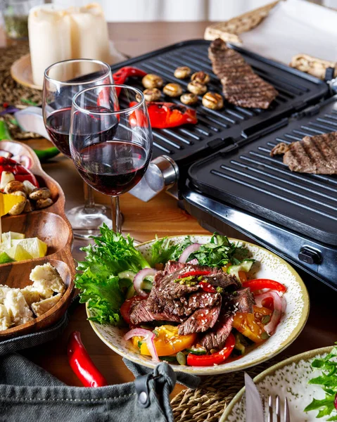 Sebzeli ızgara biftek, salata ve şarap, aperatifler.