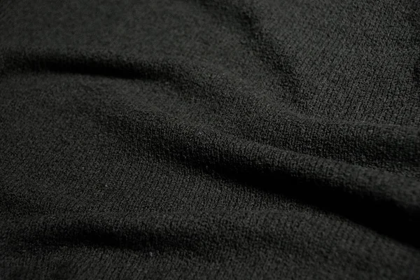 Yumuşak dalgalı ve pürüzsüz siyah kumaş dokusu