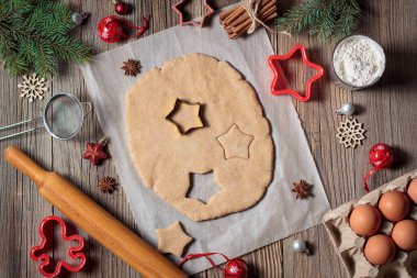 Ev yapımı zencefilli kurabiye pişirmek. Hamur baharatları ve köknar ağacıyla tatil arka planının en üst görüntüsü. Noel konseptine hazırlanılıyor