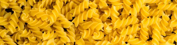 Banner Background Many Pile Pasta Spiral Fusilli — Stock Photo, Image