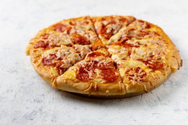 Beyaz arka planda nefis ev yapımı pepperoni pizza. Salamlı ve peynirli geleneksel klasik pizza..