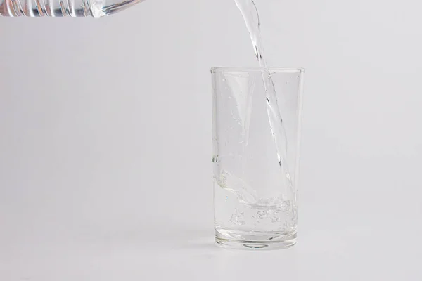 Close Gieten Gezuiverd Vers Drinkwater Uit Fles Geïsoleerd Witte Achtergrond — Stockfoto