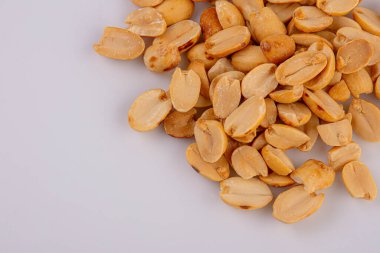 Fried and salted peanuts pile isolated on white background, Close-up