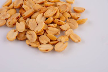 Fried and salted peanuts pile isolated on white background, Close-up