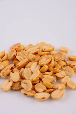 Fried and salted peanuts pile isolated on white background, Close-up