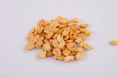 Fried and salted peanuts pile isolated on white background, Close-up