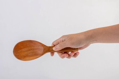 Hand and wooden spoon isolated on a white background