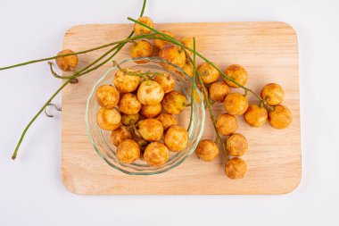 Thai fruit. Fresh ripe mafai with sweet and sour on wood table.Close-up