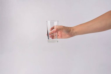 Hand and empty glass isolated on white background.