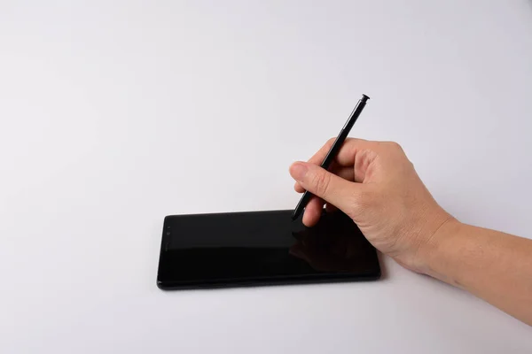 Hand and smartphone and black stylus for writing isolated on white background.