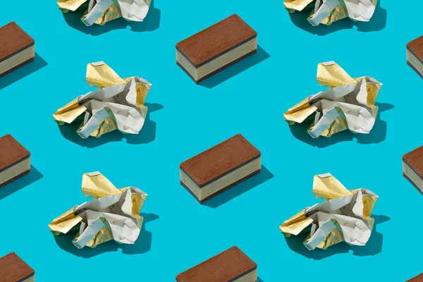 Candy bars and gold foil wrapping papers pattern on blue background.