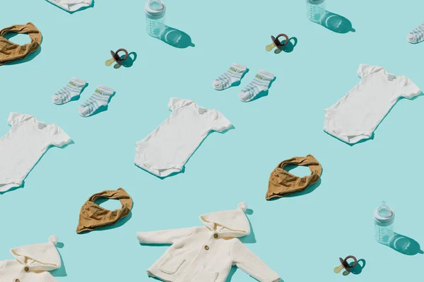 Baby pattern of clothes and accessories on a blue background.  Top view concept.