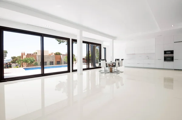 White empty room with green landscape in window.