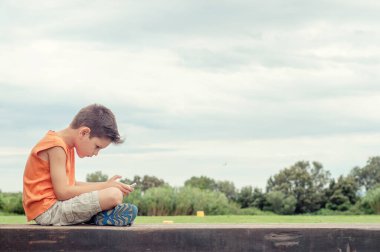 Parktaki çocuk tablet oynuyor.. 