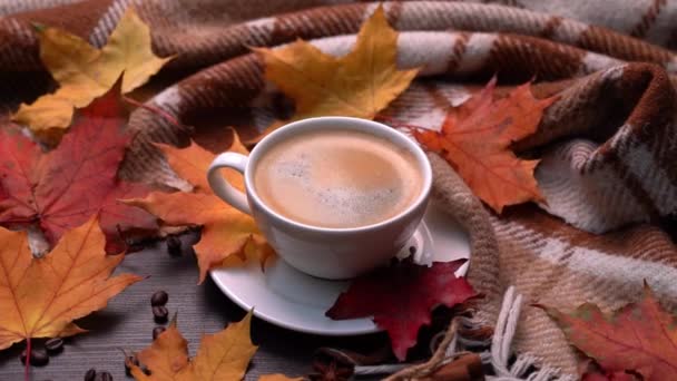 Autumn, fall leaves, hot cup of coffee and warm plaid on a wooden table background. Seasonal, morning coffee, sunday relaxing and still life concept. Camera movement in a circle — Stock Video