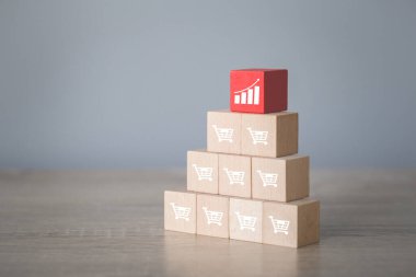 Arranging wood block stacking with icon Graph and shopping cart symbol upward direction,