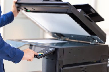 İşadamı, yazıcı fotokopi ağı panelindeki düğmeye basar, ofis konseptinde fotokopi üzerinde çalışır, yazıcı, kağıt tarama ve kopyalama için ofis çalışanı ekipmanıdır.