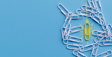 Kağıt ataç, düşünme, yaratıcılık, mavi arka planda ampul, yeni fikirler kavramı ile harika fikirler..