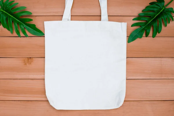 Tote bag canvas fabric cloth shopping sack mockup blank on wood backgroung.