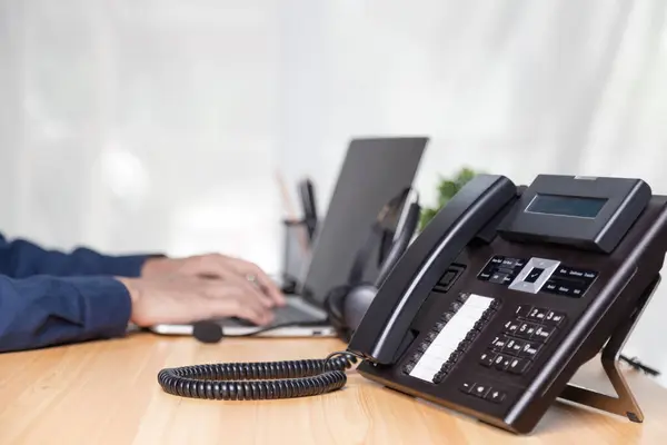 Call center staff man hand point to press the button number on the phone office desk , Communication support, call center and customer service help desk. for (call center) concept